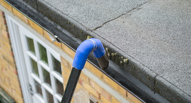 Ground-level gutter vacuum cleaning